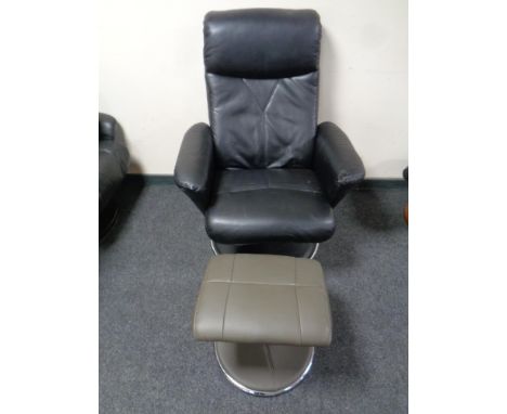 A black leather high backed manual reclining swivel armchair on chrome metal base and a similar footstool (a/f)