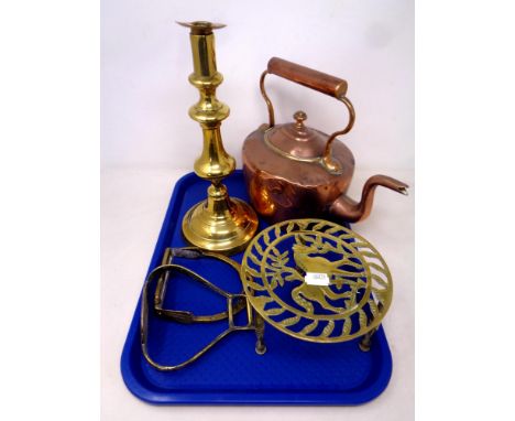 A tray of antique copper and brass wares to include copper kettle, brass trivet and candlestick, together with two brass stir