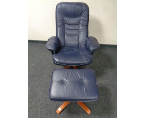 A blue leather manual reclining swivel armchair with footstool 