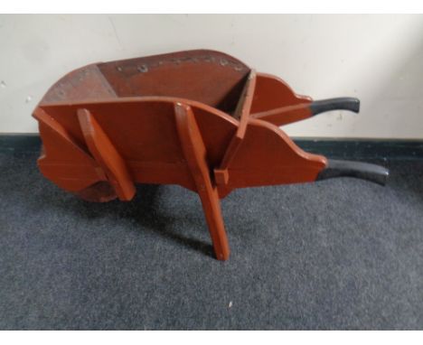 A wooden garden wheel barrow planter 