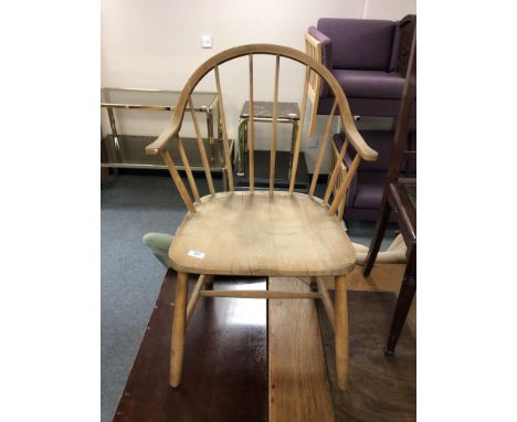 A mid century Danish pine and beech stick back armchair 