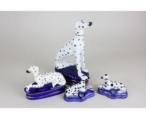 A Fitz and Floyd porcelain dalmation topped trinket box, a pair of dalmation inkwells and a dalmation ornament, 21cm high