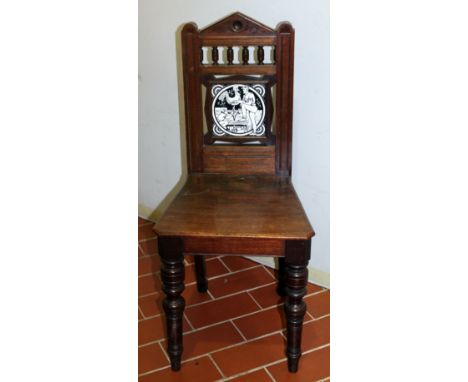 19th Century mahogany hall chair, the back is inset with black and white tile depicting men painting weather vane on turned f