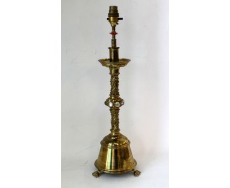 Victorian brass candlestick in the ecclesiastical Gothic style, converted for use as a table lamp, with circular drip tray on