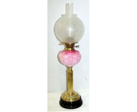 Oil lamp, the opaque pink moulded reservoir with floral and swag decoration on reeded brass column and domed plinth base with