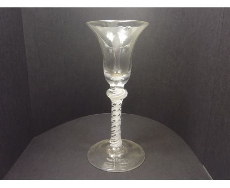 Georgian air twist wine glass, the bell shaped bowl on knopped stem and circular foot with snapped pontil, 17.5cm