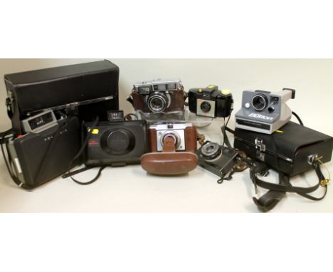 Small collection of vintage cameras including Fujica 35-EE Dacora Dignette, Kodak Brownie 127, Olympus Trip 35 and three Pola