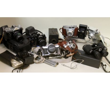 Collection of various vintage cameras including Zenit E 11, Kodak Retinett1A, Kodak Vest Pocket, Olympus OM-1, Halina Pet, Bi