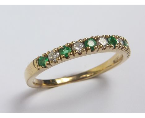 Diamond and emerald eleven stone ring of half eternity style in 9ct gold.   Condition Report.  Size N 1/2