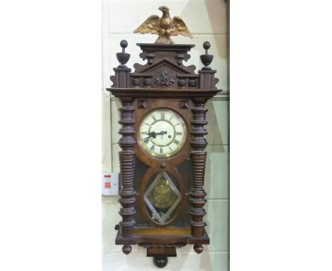 Walnut Gustav Becker Vienna wall clock, the maker's logo to the dial within a pillared glazed case surmounted by an architect