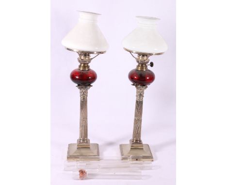Pair of ep column table lamps with ruby glass reservoir and milk glass shades, 52cm