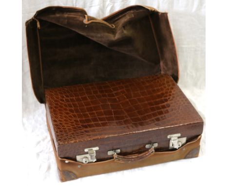 Good quality leather crocodile trunk fitted with many compartments and wells for jars and vanity items, further outer canvas 