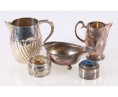 George III silver boat, indistinct marks, 11cm, two silver cream jugs, largest 9cm, a napkin ring and a Indian white metal an