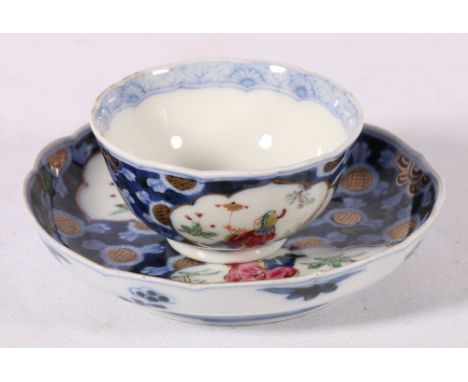 Chinese early 19th century tea bowls and saucers with shaped rims depicting a figure seated holding a puppet on a gilt ground