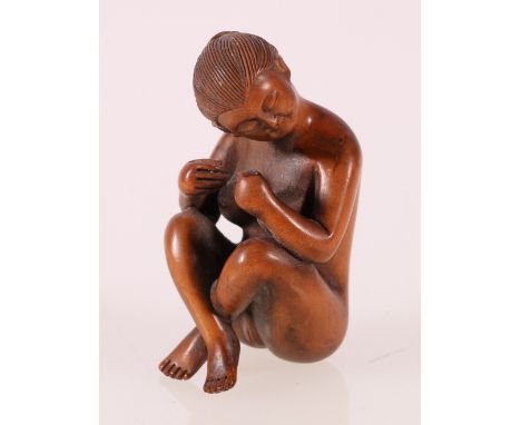 Carved boxwood netsuke of a nude female in a seated position, two character signature to rear, 5cm