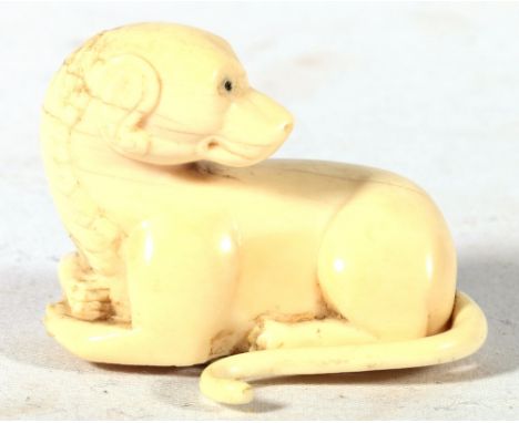 19th century carved ivory finial possibly Indian depicting a seated mythical beast, ebony inlaid eyes, 6cm.