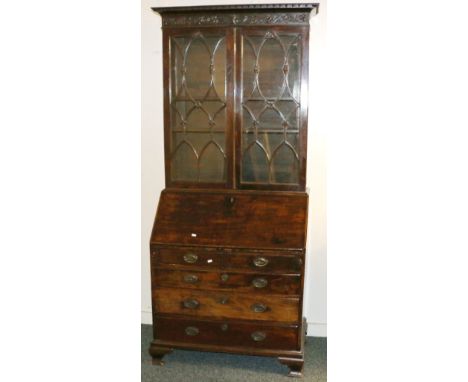 George III floral carved mahogany bureau bookcase, with scrolling foliate frieze above astragal doors, fall front and long dr