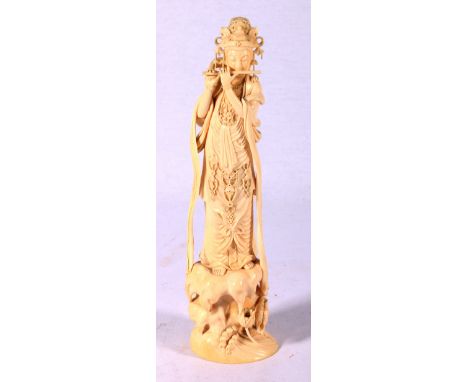 Early 20th century ivory carving of Shou Lao playing the flute and a naturalistic rock base with water lillies, green seal ma