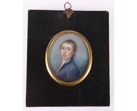 19th CENTURY SCHOOL Bust length Portrait miniature of a young man in blue jacket Unsigned, watercolour on sheet ivory, 6.5cm 