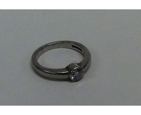 A diamond single stone gypsy set ring in rubover mount. Approx. 6.3 grams. Est. £250 - £300.