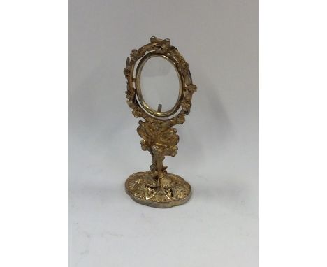 A small silver gilt Continental picture frame on oval stand. Approx. 36 grams. Est. £30 - £40.