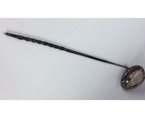 A Georgian silver toddy ladle with twisted whalebone handle. London. By SM. Est. £30 - £50.