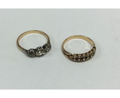 An Antique double row pearl ring set in gold together with a 9 carat example. Approx. 4 grams. Est. £50 - £80.