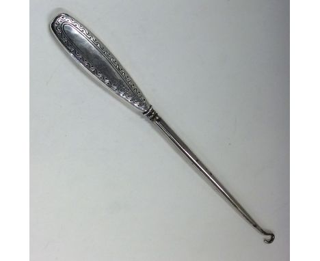 LIBERTY &amp; CO: A silver mounted button hook of typical form. Approx. 70 grams. Est. £30 - £40.