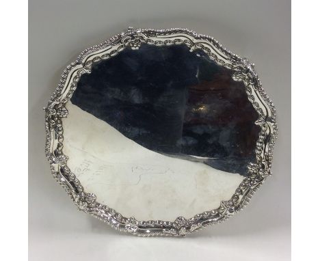 An attractive Georgian circular silver salver with gadroon rim to ball and claw feet. London. By EC. Approx. 613 grams. Est. 