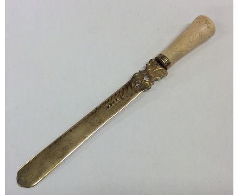 A Victorian silver gilt tapering letter opener with ivory handle of Chinese design. Approx. 58 grams. Est. £30 - £40.
