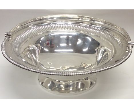 PAUL STORR: A large circular silver fruit basket with gadroon rim to fluted bowl and reeded swing handle. London 1805. Approx