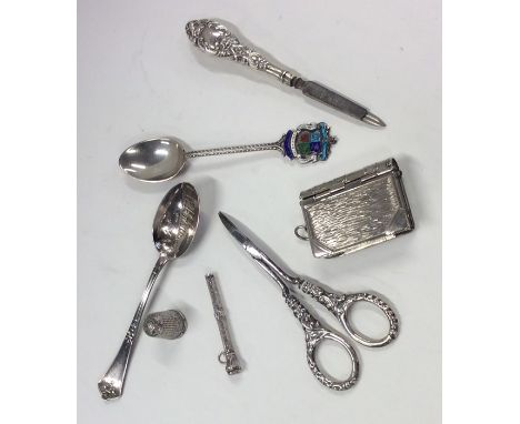 A bag containing silver spoons, scissors etc. Approx. 124 grams. Est. £35 - £45.