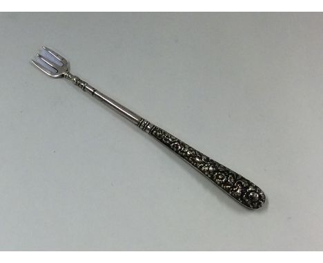 A Continental silver tapering fork embossed with flowers and leaves. Approx. 10 grams. Est. £10 - £20.