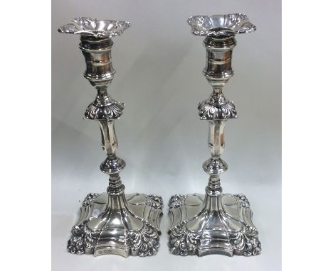 A good tall pair of Georgian style silver candlesticks with scroll decoration. Sheffield. By HE. Approx. 1400 grams. Est. £40