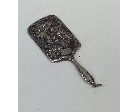 A miniature silver handbag mirror embossed with figures. Approx. 20 grams. Est. £15 - £20.