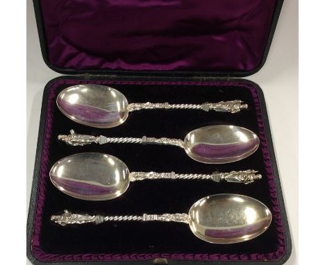 A cased set of four silver apostle top spoons with gilt terminals. Sheffield. Approx. 280 grams. Est. £100 - £150.