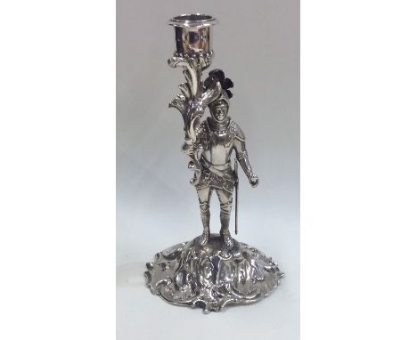 An unusual silver candlestick in the form of a warrior on textured base. London. Approx. 334 grams. Est. £250 - £350.