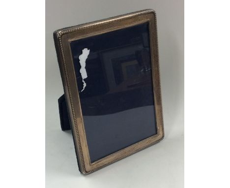 A modern rectangular silver picture frame with reeded border. London. By RC. Est. £20 - £30.