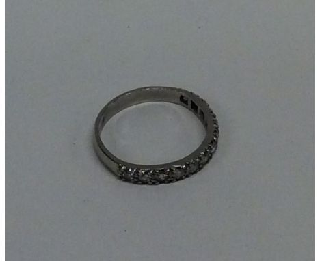 An attractive diamond half eternity ring in platinum setting. Approx. 3.1 grams. Est. £100 - £200.