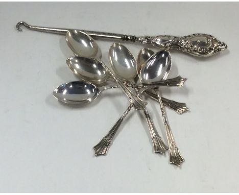 A set of six silver coffee spoons with twisted terminals, together with a silver button hook. Approx. 93 grams, Est. £20 - £3