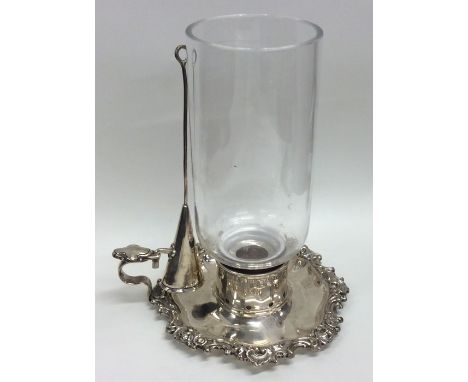 A rare Georgian silver storm lamp attractively decorated with scrolls and flowers with matching extinguisher. Approx. 337 gra