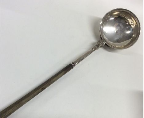 A Scottish silver toddy ladle with whale bone handle chased with leaves. Approx.85 grams. Est. £150 - £250.