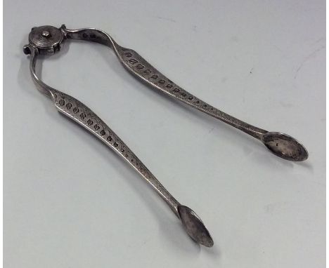 A good pair of early Georgian silver bright cut sugar nips with spring mechanism. Approx. 45 grams. Est. £60 - £80.