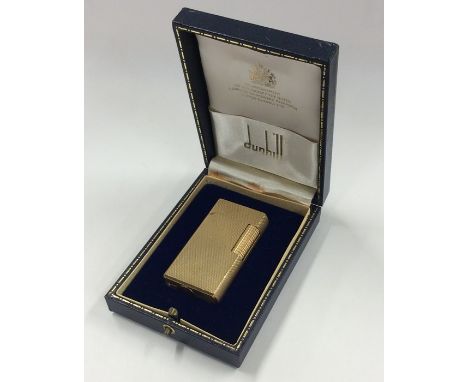 DUNHILL: A cased lighter of engine turned decoration. Est. £30 - £40.