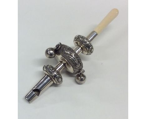 A heavy Chinese silver rattle inset with dragons. Approx. 52 grams. Est. £80 - £120.
