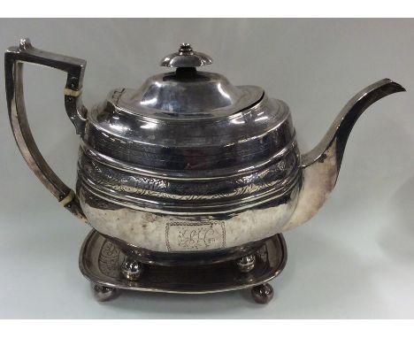 A good Georgian silver bright cut teapot attractively decorated with flowers and leaves to ball feet with a matched stand. Ap