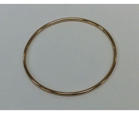 A 9 carat plain bangle. Approx. 11 grams. Est. £120 - £150.
