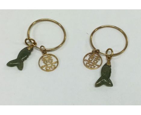 A pair of Chinese gold and jade earrings with carved decoration. Approx. 2.1 grams. Est. £35 - £45.