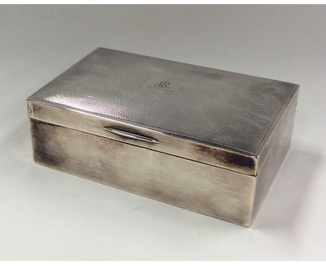 A heavy silver engine turned cigarette box. Birmingham. By JR. Approx. 411 grams. Est. £25 - £35.