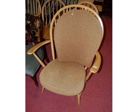 An Ercol light elm stickback open armchair 